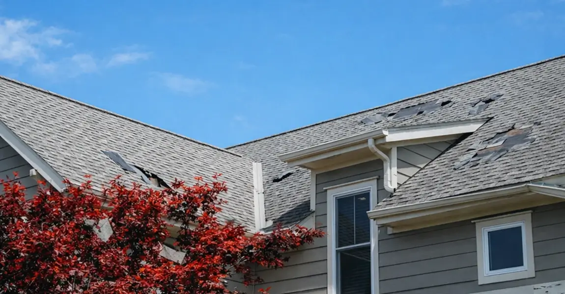 Image showing a residential home with storm roof damage in Missouri